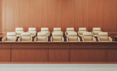 A courtroom with wooden paneling and chairs.