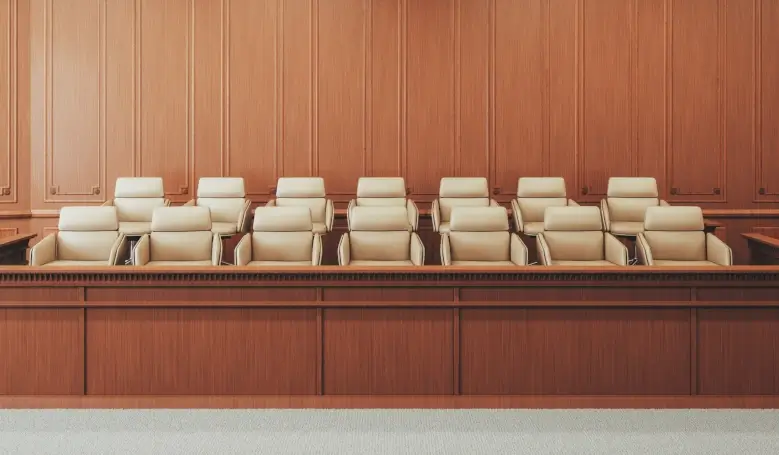 A courtroom with wooden paneling and chairs.